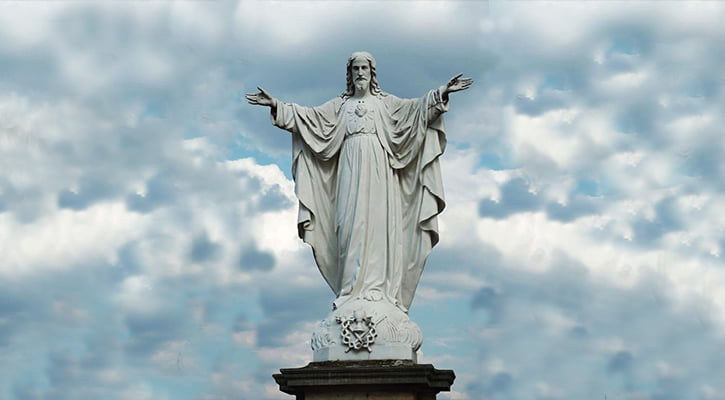 White marble Jesus statue with hands open